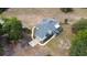 Aerial view of a two-story home featuring a screened pool, side entry garage and a gray shingled roof at 24025 Ranch Rd, Astatula, FL 34705