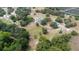 Aerial view of a property with a single Gathering home and a storage building at 24025 Ranch Rd, Astatula, FL 34705