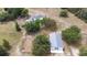Aerial view of a home and barn on a grassy lot with trees and fenced area at 24025 Ranch Rd, Astatula, FL 34705