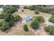 Aerial view of a property with a single Gathering home and a storage building at 24025 Ranch Rd, Astatula, FL 34705