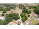 Aerial view showcases a sprawling property with lush trees and a long driveway at 24025 Ranch Rd, Astatula, FL 34705