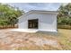 Exterior shot of white metal barn with sliding door and concrete pad at 24025 Ranch Rd, Astatula, FL 34705