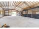 Large barn interior with concrete floor and multiple horse stalls at 24025 Ranch Rd, Astatula, FL 34705