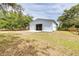 Exterior shot of white metal barn with sliding door open to a paddock at 24025 Ranch Rd, Astatula, FL 34705
