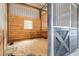 Interior shot of a barn stall with wood paneling and metal bars at 24025 Ranch Rd, Astatula, FL 34705