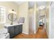 Bright bathroom with a single vanity, walk-in shower, and access to the main bedroom at 24025 Ranch Rd, Astatula, FL 34705