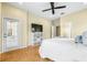 Bright bedroom with a door to the patio, modern ceiling fan, herringbone floors, and neutral wall color at 24025 Ranch Rd, Astatula, FL 34705