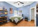Charming bedroom featuring a ceiling fan, herringbone wood floors, and unique decor at 24025 Ranch Rd, Astatula, FL 34705