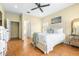 Serene bedroom with a white bed, stylish decor, herringbone floors, and ample natural light at 24025 Ranch Rd, Astatula, FL 34705