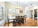 Bright dining area with a wooden table, view of the backyard, and convenient access to the laundry area at 24025 Ranch Rd, Astatula, FL 34705
