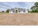 Charming exterior elevation of the home with a green front door and well-manicured lawn at 24025 Ranch Rd, Astatula, FL 34705