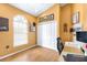 Well-lit home office features herringbone floors, natural light, and a convenient workspace at 24025 Ranch Rd, Astatula, FL 34705