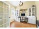 Bright home office with a modern chandelier, stylish cabinets, and light walls at 24025 Ranch Rd, Astatula, FL 34705