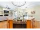 Open kitchen view featuring a granite countertop island and seamlessly connected living and dining spaces at 24025 Ranch Rd, Astatula, FL 34705
