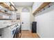Convenient laundry room features modern appliances, shelving and stylish decor at 24025 Ranch Rd, Astatula, FL 34705