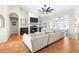 Comfortable living room with a fireplace, ceiling fan, and french doors to the outside at 24025 Ranch Rd, Astatula, FL 34705