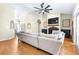 Spacious living room featuring wood floors, a fan, and a cozy fireplace at 24025 Ranch Rd, Astatula, FL 34705
