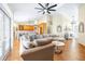 Inviting living room with wood floors, comfortable seating, and an open layout to the kitchen at 24025 Ranch Rd, Astatula, FL 34705