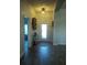 Bright foyer with wood-look tile flooring, white trim, decorative console table, and front door with glass panels at 4616 Grandview Glen Dr, Auburndale, FL 33823