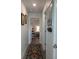 Charming hallway with decoratively carpet, and framed art leading to rooms in the house at 4616 Grandview Glen Dr, Auburndale, FL 33823