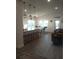 Open-concept living area featuring a kitchen bar, dining table, and cozy living room at 4616 Grandview Glen Dr, Auburndale, FL 33823