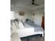 This well-lit main bedroom features tray ceiling, comfortable seating, and ensuite bathroom at 4616 Grandview Glen Dr, Auburndale, FL 33823