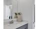 Modern bathroom featuring a vanity with gray cabinets, quartz countertop, and designer fixtures at 606 Terrapin Dr, Debary, FL 32713