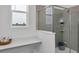 Bathroom with window, walk-in shower with glass enclosure, and neutral color palette at 606 Terrapin Dr, Debary, FL 32713
