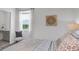Bright bedroom featuring a window with a view, comfortable bed and stylish decor at 606 Terrapin Dr, Debary, FL 32713