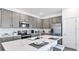 Modern kitchen with stainless steel appliances, gray cabinets, and a large island at 606 Terrapin Dr, Debary, FL 32713