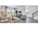 Bright and airy living room with large windows, modern furniture, and stylish decor at 606 Terrapin Dr, Debary, FL 32713