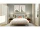 Neutral bedroom with white linens, bedside tables and lamps, dinosaur-themed artwork, and blue rug at 7244 Summer Ivy Aly, Orlando, FL 32829