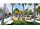 Community playground featuring hammocks, Adirondack chairs, a large play structure, and shady trees at 7244 Summer Ivy Aly, Orlando, FL 32829