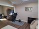 Versatile bonus room featuring a treadmill, wardrobe, and wood-look flooring, perfect for a home gym or office at 242 Rosa Blanca, Winter Haven, FL 33884