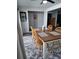 Cozy dining area with a wooden table, four chairs, and a decorative rug on the floor at 242 Rosa Blanca, Winter Haven, FL 33884