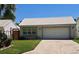 Charming single-story home with a well-maintained lawn and a white tile roof, offering classic curb appeal at 242 Rosa Blanca, Winter Haven, FL 33884