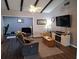 Comfortable living room with wood floors, ceiling fan, exposed beams, and abundant natural light at 242 Rosa Blanca, Winter Haven, FL 33884