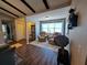 Inviting living room featuring hardwood floors, ceiling beams, and a cozy seating area with neutral tones at 242 Rosa Blanca, Winter Haven, FL 33884