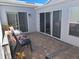 Cozy outdoor patio area with brick pavers, sliding glass doors, and comfortable seating at 242 Rosa Blanca, Winter Haven, FL 33884