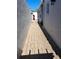 Narrow side yard between two white buildings with brick pavers and a charming, private outdoor space at 242 Rosa Blanca, Winter Haven, FL 33884