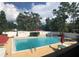 Large community swimming pool surrounded by lush greenery, and a well-maintained pool deck at 242 Rosa Blanca, Winter Haven, FL 33884