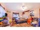 A disorganized bedroom featuring a queen bed, dresser, an armchair, and cluttered items at 117 Sw 3Rd Ave, Mulberry, FL 33860