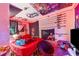 Bedroom interior featuring a red comforter, fishing rods, and posters at 117 Sw 3Rd Ave, Mulberry, FL 33860