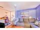 Living room featuring a blue accent wall, hardwood floor, and an adjoining room at 117 Sw 3Rd Ave, Mulberry, FL 33860