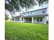 Expansive backyard with a well-maintained lawn and a covered patio area at 13525 Gorgona Isle Dr, Windermere, FL 34786
