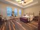 This bedroom has hardwood floors, a ceiling fan, and many windows for plenty of light at 13525 Gorgona Isle Dr, Windermere, FL 34786