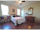 Charming bedroom with a carved wooden bed frame, and hardwood floors at 13525 Gorgona Isle Dr, Windermere, FL 34786
