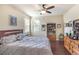 Comfortable bedroom featuring a ceiling fan, two windows, and ample storage space at 13525 Gorgona Isle Dr, Windermere, FL 34786