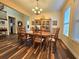 Traditional dining room features wood floors, chandelier, and large cabinet for storage and display at 13525 Gorgona Isle Dr, Windermere, FL 34786