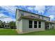Exterior view of home highlighting the backyard, multiple windows, and well-maintained landscaping at 13525 Gorgona Isle Dr, Windermere, FL 34786